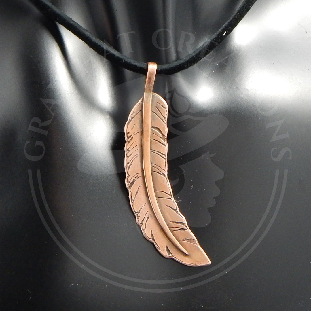 Copper feather pendant necklace on leather cord